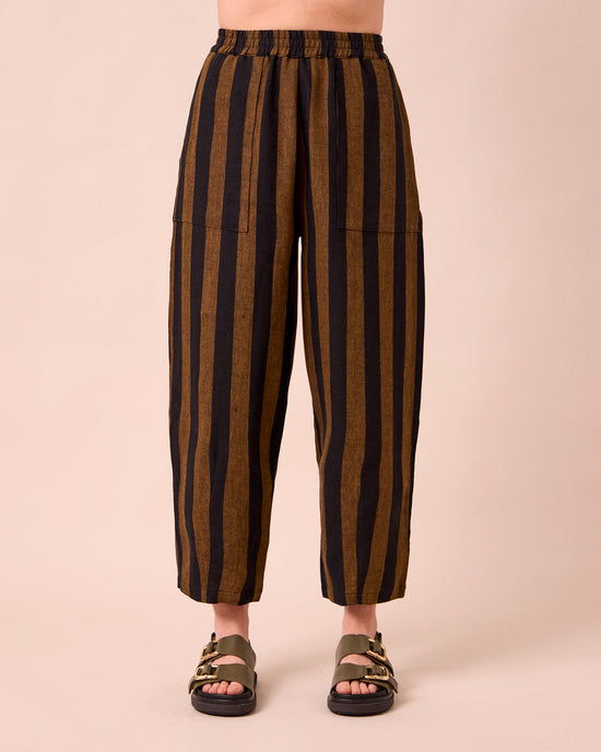 model wears huxley rust stripe linen trousers front