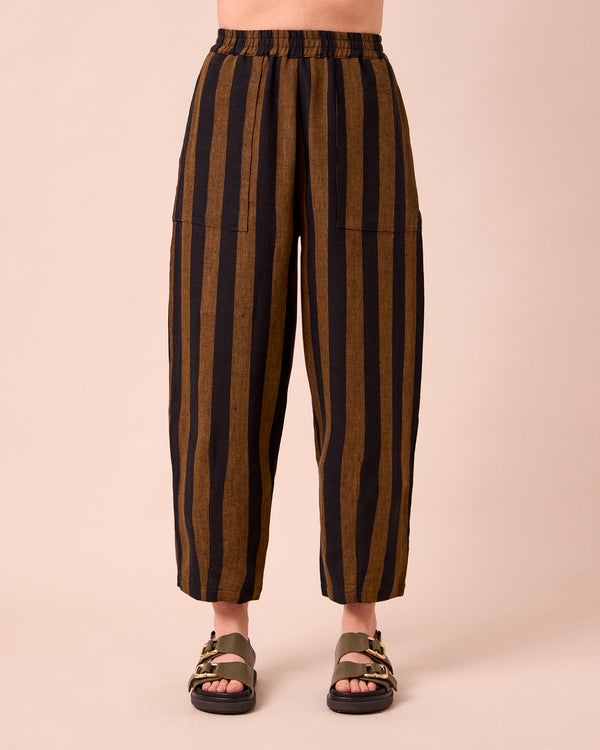 model wears huxley rust stripe linen trousers front