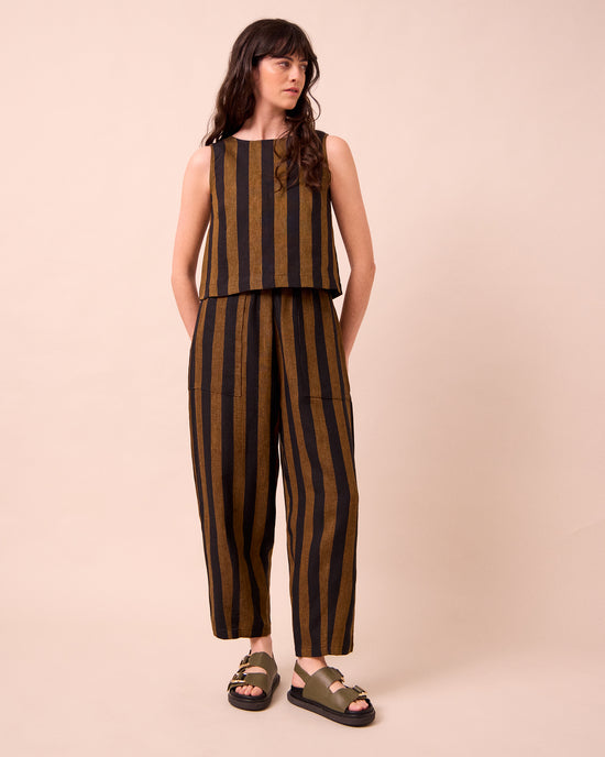 model wears huxley rust stripe linen trousers right
