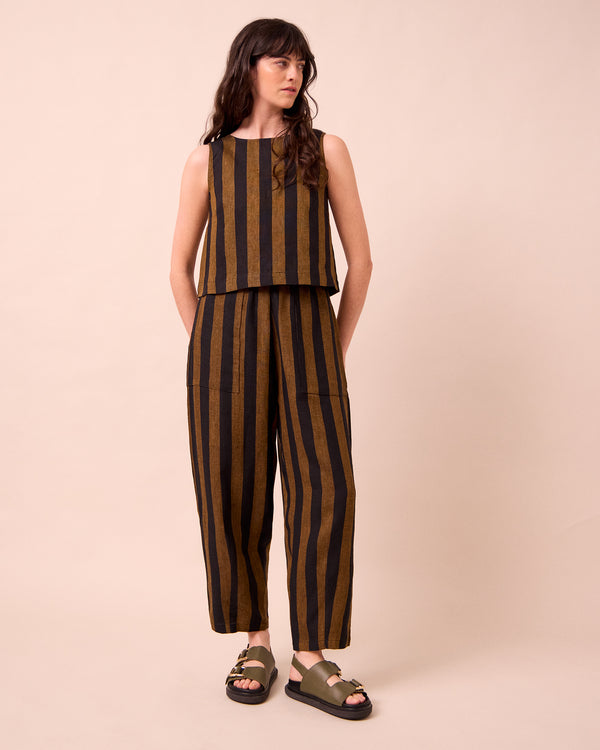 model wears huxley rust stripe linen trousers right