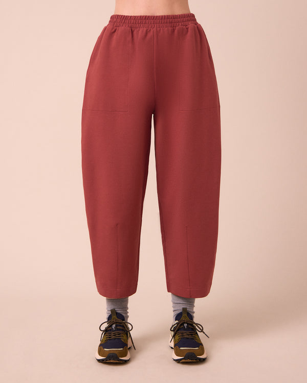 model wears huxley brick jersey trousers front