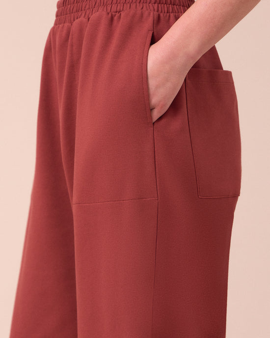 model wears huxley brick jersey trousers 