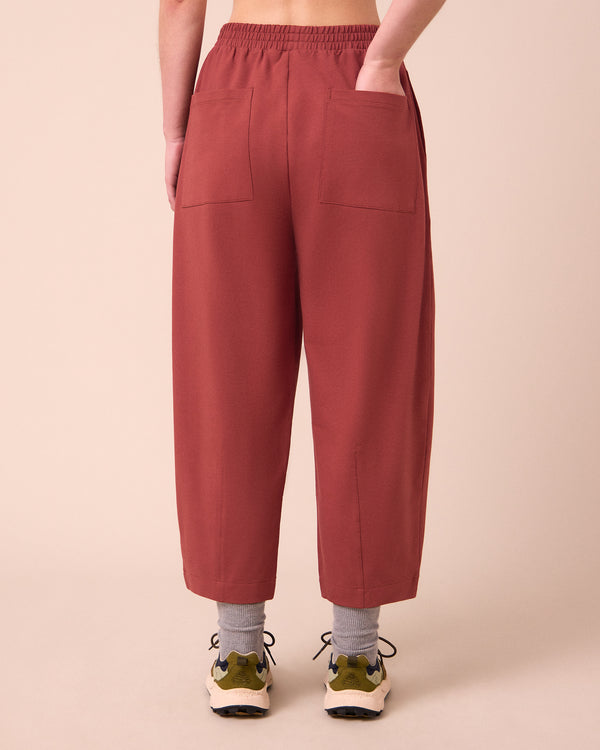 model wears huxley brick jersey trousers back