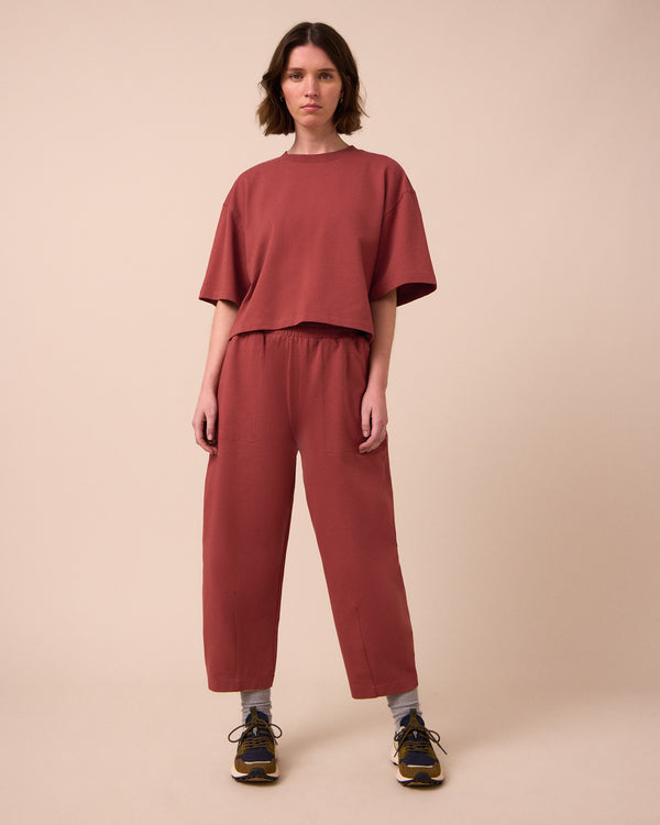 model wears huxley brick jersey trousers left