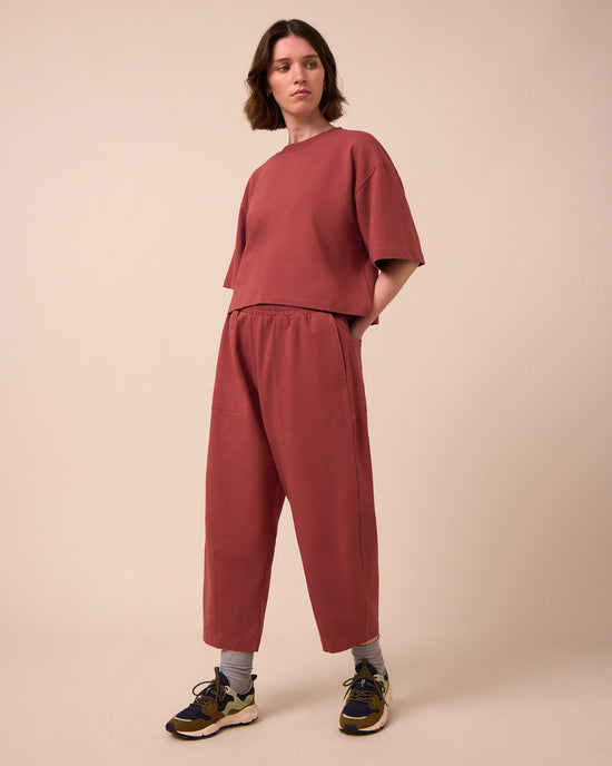 model wears huxley brick jersey trousers right