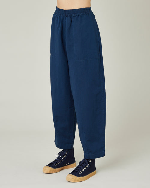 model wears navy twill huxley trousers left