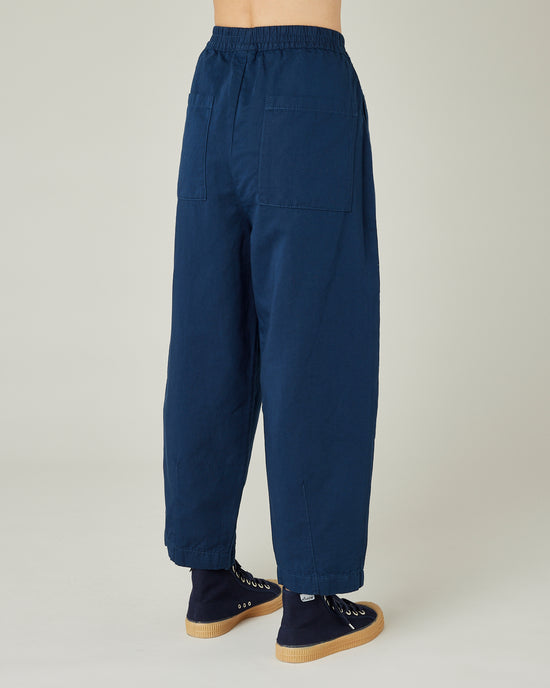 model wears navy twill huxley trousers right