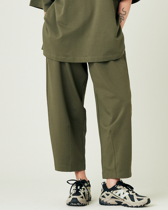 model wears olive huxley jersey trousers front