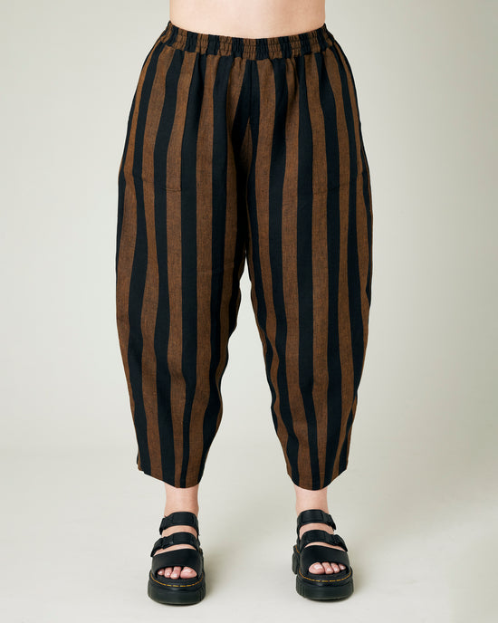 model wears rust stripe huxley trousers