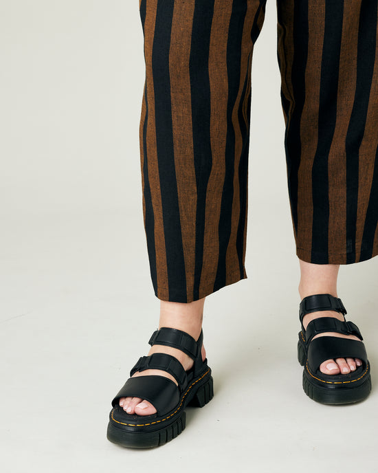 model wears rust stripe huxley trousers