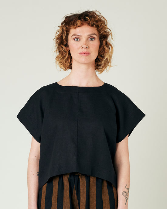 model wears black linen polly top