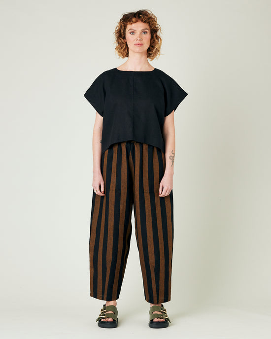 model wears rust stripe huxley trousers