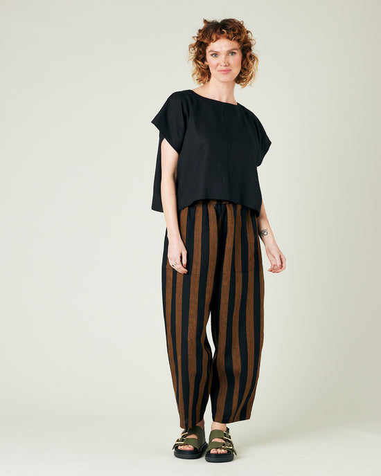 model wears rust stripe huxley trousers