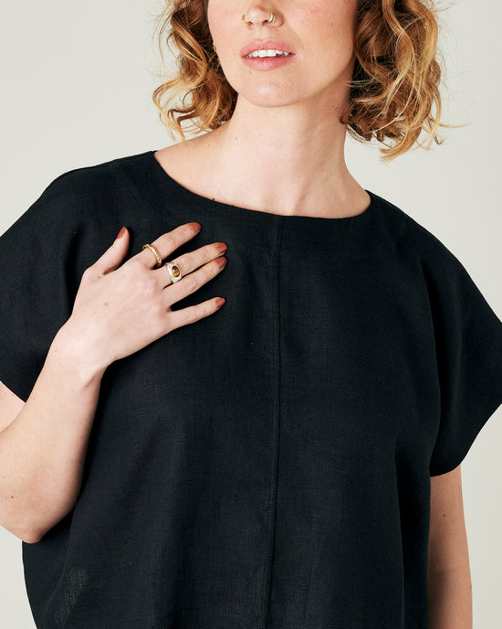 model wears black linen polly top