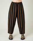 model wears rust stripe huxley trousers front