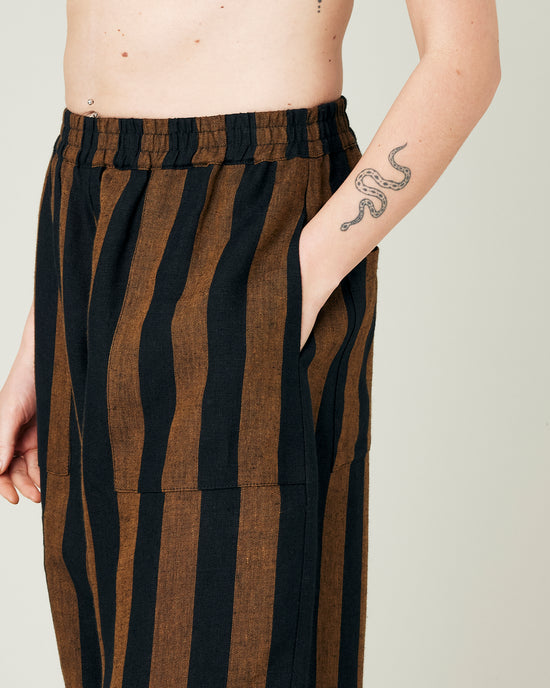 model wears rust stripe huxley trousers