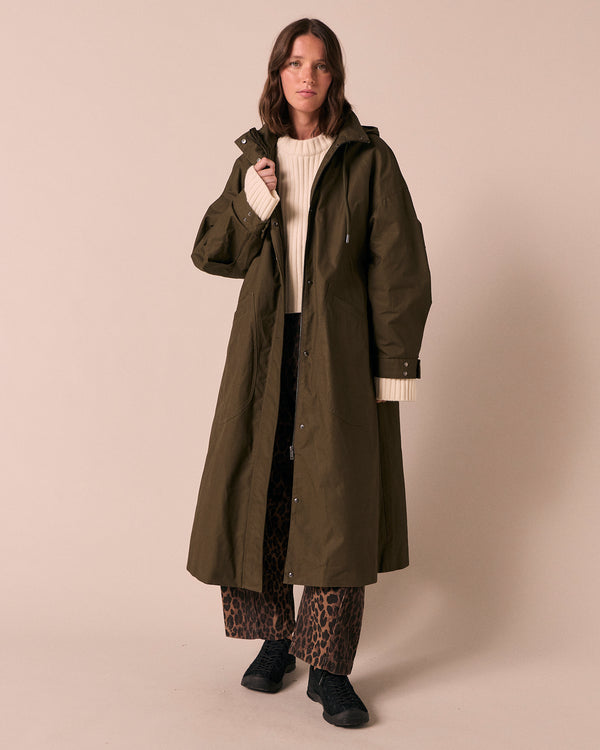 model wears indy dark olive coated cotton jacket