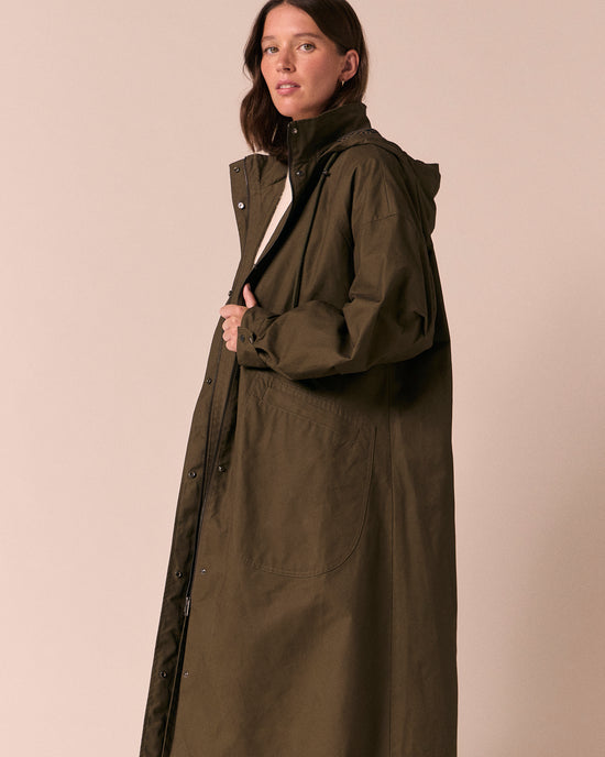 model wears indy dark olive coated cotton jacket
