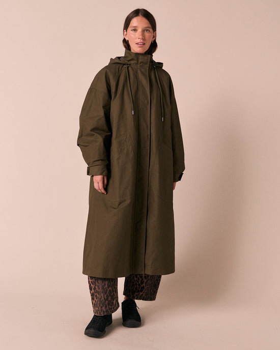 model wears indy dark olive coated cotton jacket