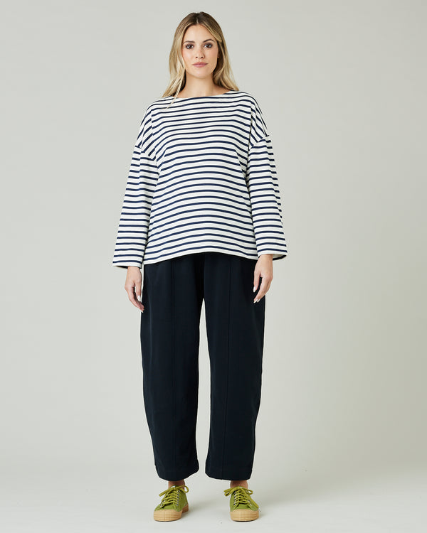pregnant model wears ecru and navy striped breton top