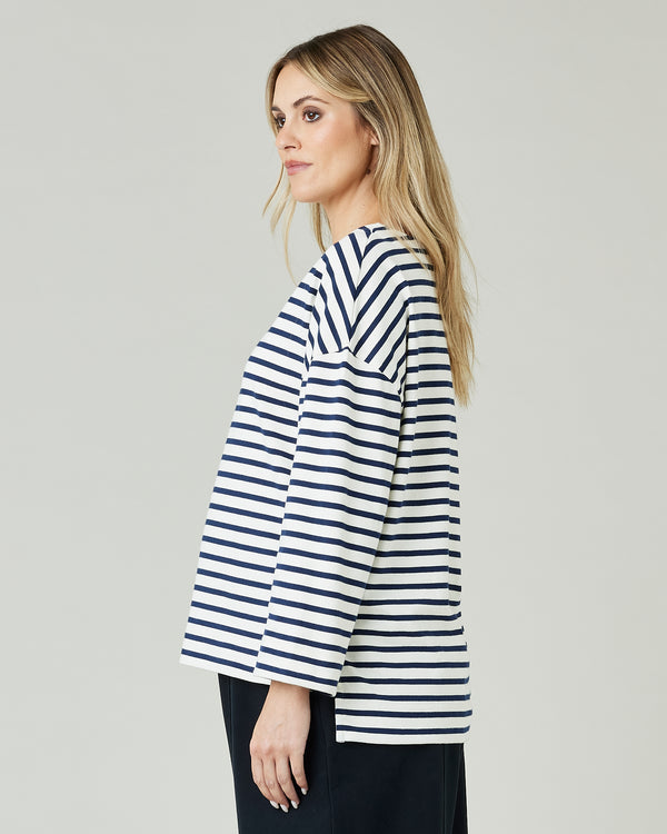 pregnant model wears ecru and navy striped breton top