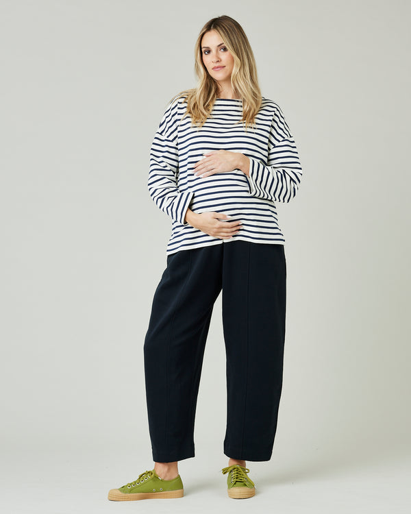 pregnant model wears ecru and navy striped breton top