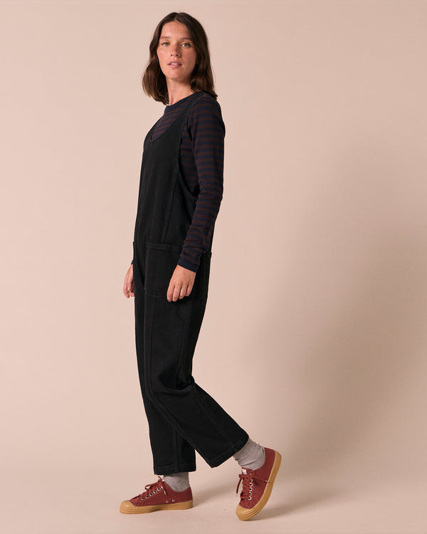 model wears jolie black denim jumpsuit