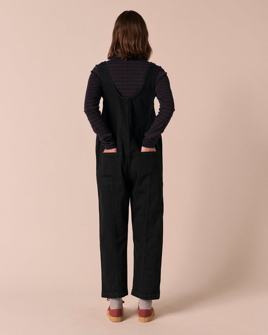 model wears jolie black denim jumpsuit