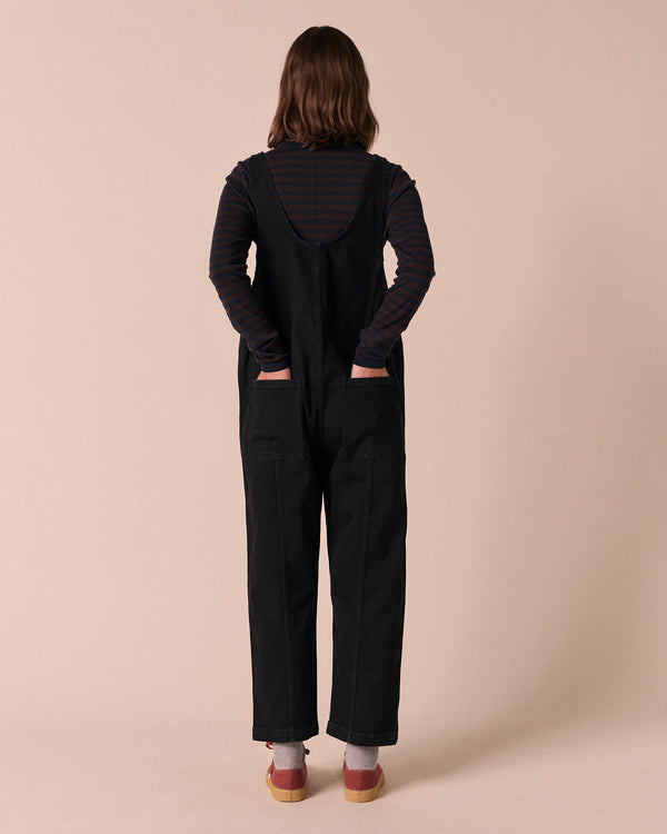 model wears jolie black denim jumpsuit