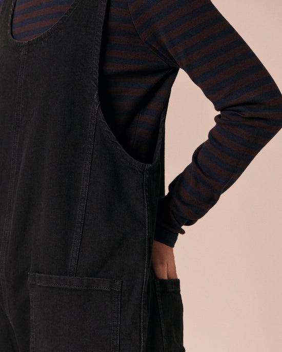 model wears jolie black denim jumpsuit