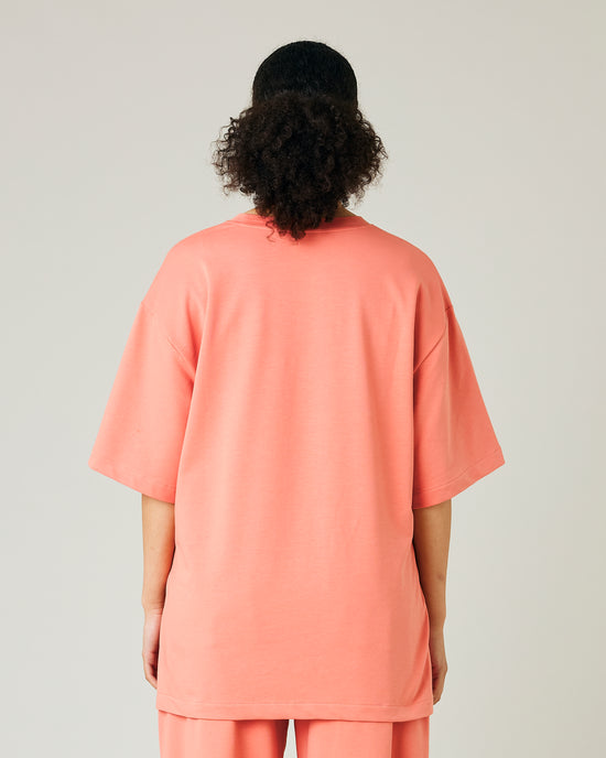 model wears coral jersey jude top