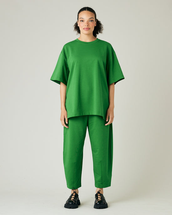 model wears juniper green huxley jersey trousers