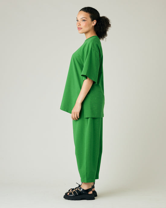 model wears juniper green huxley jersey trousers