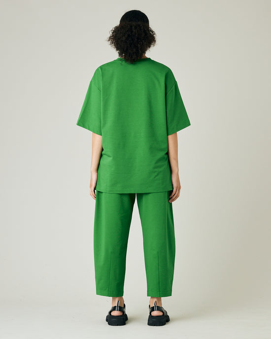 model wears juniper green huxley jersey trousers