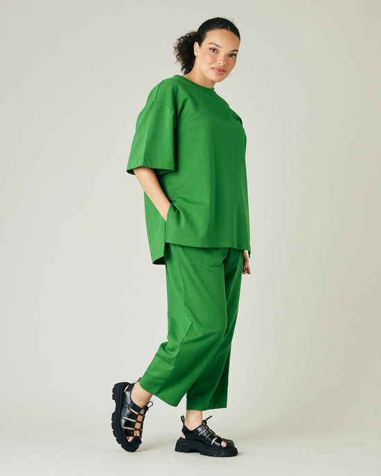 model wears juniper green huxley jersey trousers