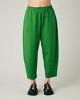 model wears juniper green huxley jersey trousers front