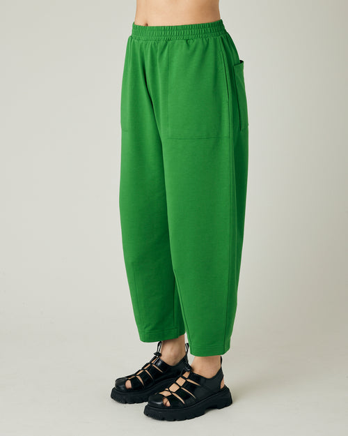 model wears juniper green huxley jersey trousers left