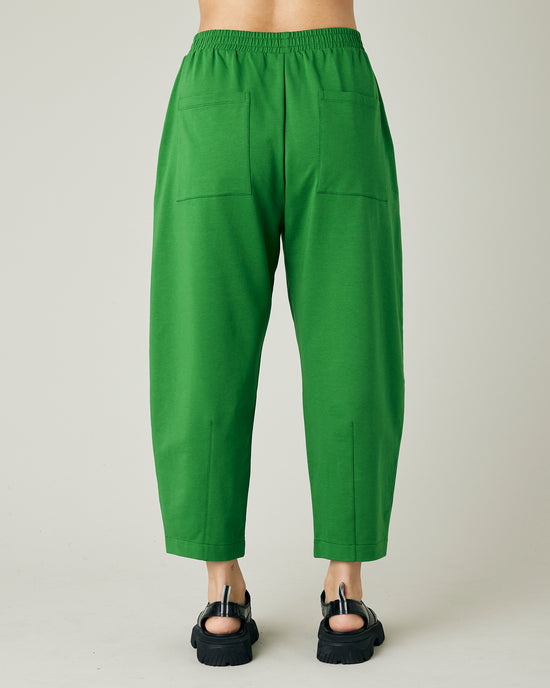 model wears juniper green huxley jersey trousers back