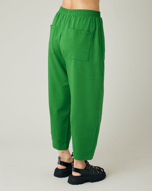 model wears juniper green huxley jersey trousers right