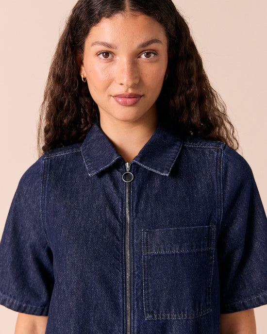 model wears juno dark wash denim jumpsuit.