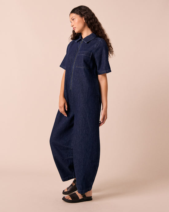 model wears juno dark wash denim jumpsuit.
