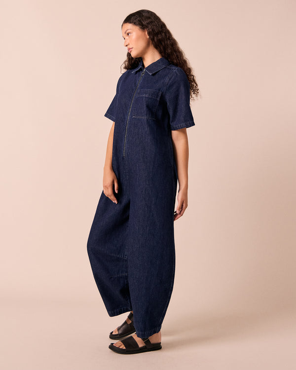 model wears juno dark wash denim jumpsuit.