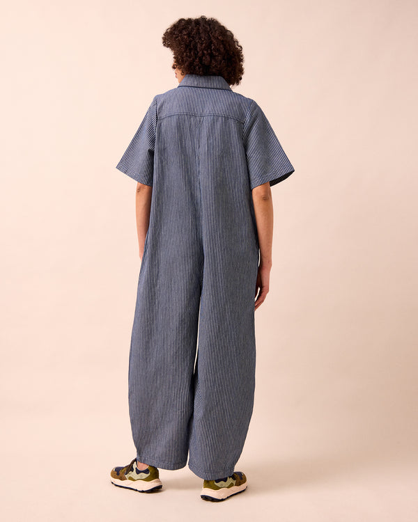 model wears juni navy hickory stripe denim jumpsuit