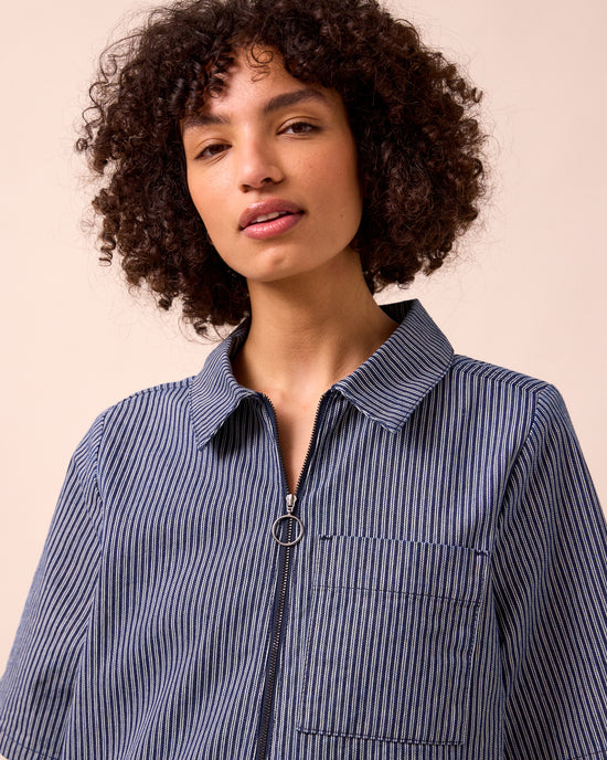 model wears juni navy hickory stripe denim jumpsuit