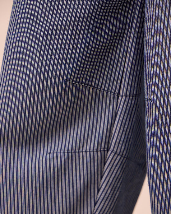 model wears juni navy hickory stripe denim jumpsuit