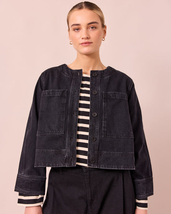 model wears kat washed black denim jacket