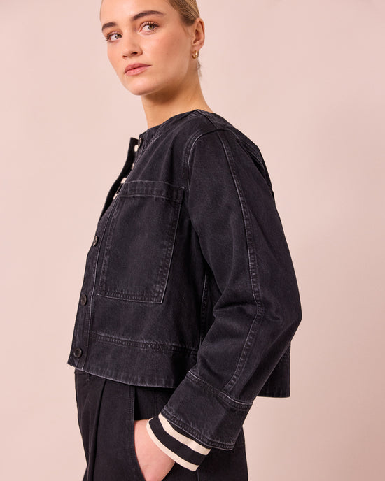 model wears kat washed black denim jacket