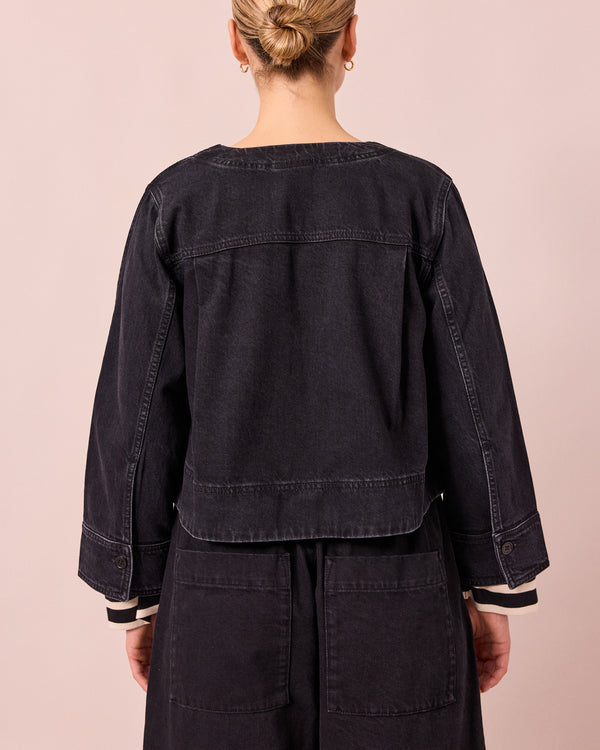 model wears kat washed black denim jacket