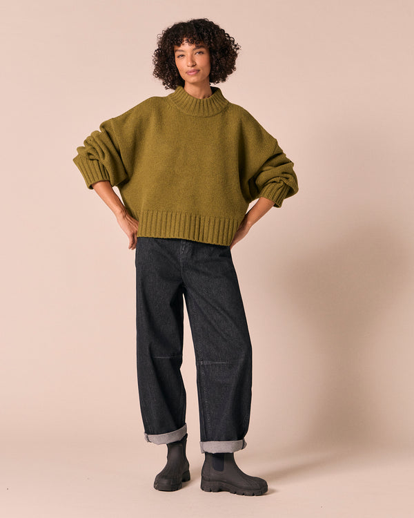 model wears kimi moss green knitted jumper
