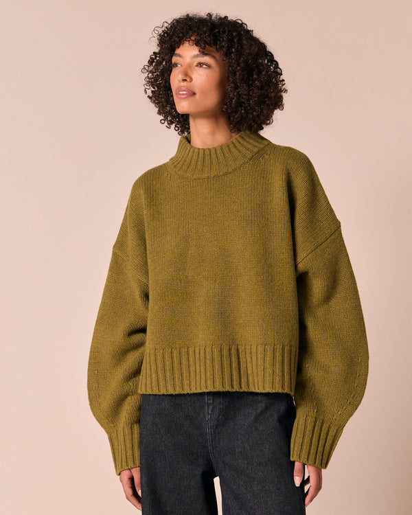 model wears kimi moss green knitted jumper